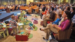 Children playing on a mat during worship