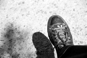 a shoe with it's shadow on the ground