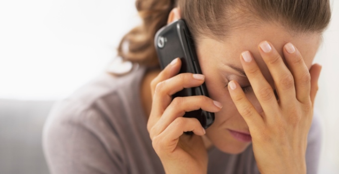 stressed young woman talking mobile phone